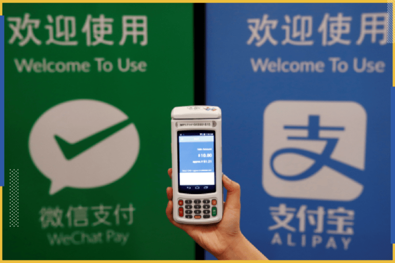 A woman demonstrates a high security digital unit built by Motion Pay, that allows customers to pay in Chinese yuan renminbi using Chinese online money payment services "WeChat Pay", and "Alipay", where payments get converted to Canadian dollars at point of sales locations in Canadian stores and businesses, in Toronto, Canada, May 24, 2017. This logo has been updated and is no longer in use. REUTERS/Mark Blinch