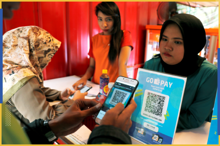 A customer uses a smartphone to scan code during pay food using Go Pay at a food counter during Go-Food festival in Jakarta, Indonesia, October 27, 2018. Picture taken October 27, 2018. REUTERS/Beawiharta