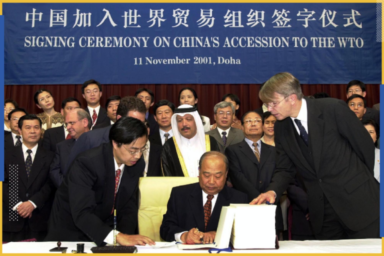 China's Foreign Trade Minister Shi Guangsheng signs the membership document at the signing ceremony for China's new membership to the WTO on the third day of the conference in Doha, November 11, 2001. U.S. President Bush Sunday welcomed the World Trade Organization's approval of membership for China and Taiwan, saying it would strengthen the global trading system and expand economic growth. REUTERS/POOL NH/RKR