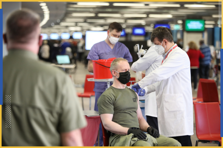 epa09093698 Members of uniformed services receive the Astra Zeneca COVID-19 vaccine at the at the National Stadium in Warsaw, Poland, 24 March 2021, amid the ongoing pandemic of the COVID-19 disease caused by the SARS-CoV-2 coronavirus. ...