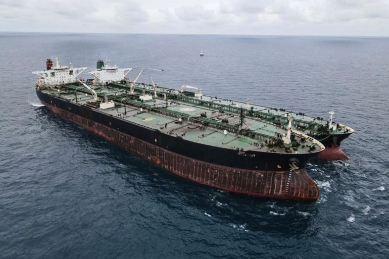 In this photo released by Indonesian Maritime Security Agency (BAKAMLA), Panamanian-flagged MT Frea, left, and Iranian-flagged MT Horse tankers are seen anchored together in Pontianak waters off Borneo island, Indonesia, Sunday, Jan. 24, 2021. Indonesian authorities said that they seized the two vessels suspected of carrying out the illegal transfer of oil in their country's waters. (Indonesian Maritime Security Agency via AP)