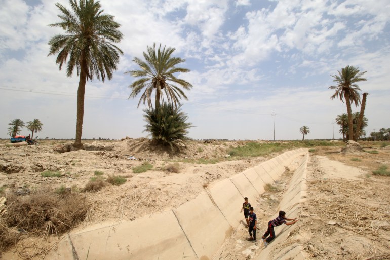 A view of a dried irrigation channel is seen in a field in Rumaitha district in Samawa