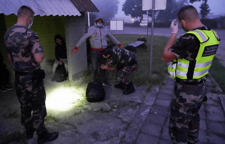 Lithuanian border guards detain migrants illegally crossing the border from Belarus to Lithuania, in Kalviai REUTERS/Janis Laizans