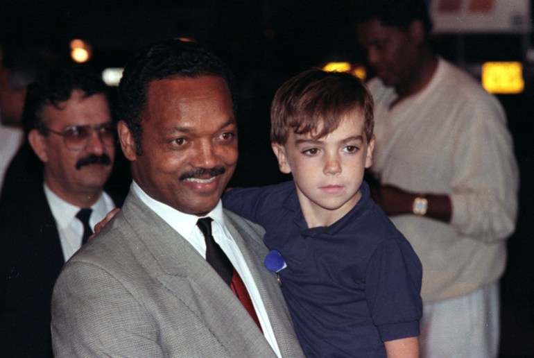 FILE PHOTO - JESSE JACKSON CARRIES A BOY OFF PLANE AFTER BEING RELEASED FROM IRAQ.
