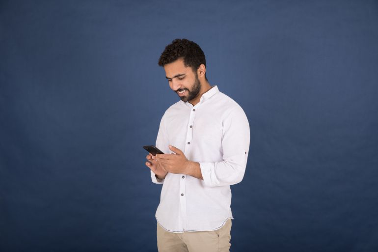 Title 1107680741 Category ShutterStock, Shutter Stock, Technology File Type jpg Picture Size 6720 x 4480 Description Handsome young man wearing a casual outfit and holding his phone chatting with friends, standing on a navy background Keywords ShutterStock, Shutter Stock, pants, navy, happy, screen, fingers, smile, outfit, white, positivity, casual, friend, latin, text, conversation, eastern, attractive, beard, touch, cheerful, look, hairstyle, phone, background, indoor, arms, style, adult, arab, handsome, muslim, young, egyptian, arabian, boy, cute, mustache, holding, east, modern, man, stand, hand, expression, social, confidence, people, elegance, shirt, 20s, chat