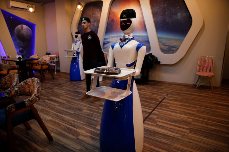 Robots deliver food to customers at a restaurant which recently opened in the city of Mosul