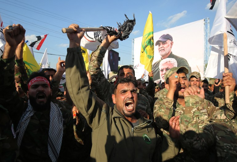 Members of the Hashed al-Shaabi paramilitary force chant anti-US slogans during a protest over the killings of Iranian commander Qassem Soleimani and Iraqi paramilitary commander Abu Mahdi Al-Muhandis, on January 6, 2020 in Karrada in central Baghdad. (Photo by AHMAD AL-RUBAYE / AFP)