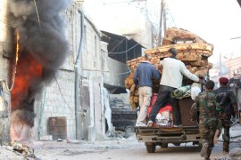 People loot furniture after soldiers loyal to Syria's President Bashar al-Assad took control of Hujaira town from rebel fighters, in the town south of Damascus