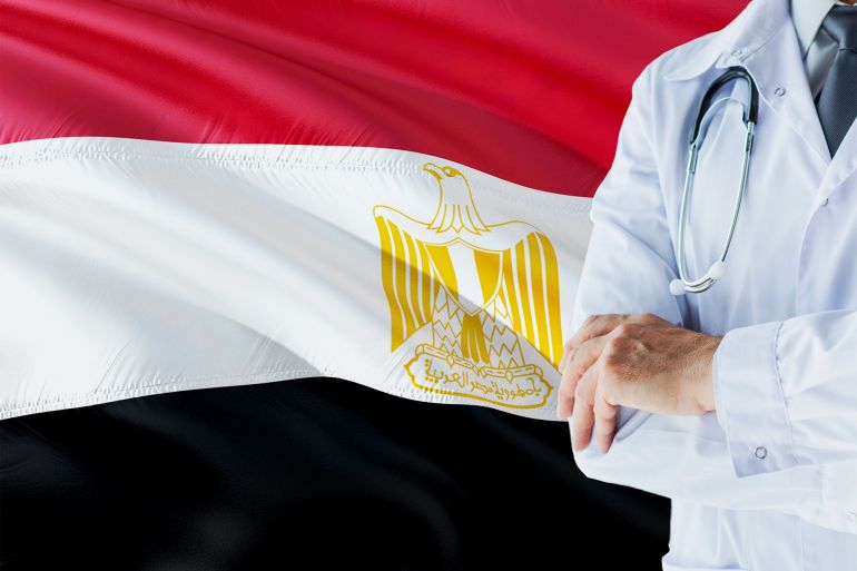 Egyptian Doctor standing with stethoscope on Egypt flag background. National healthcare system concept, medical theme.Egyptian Doctor standing with stethoscope on Egypt flag background. National healthcare system concept, medical theme.Egyptian Doctor sta Creative #: 1130572571 الطبيب المصري غيتي