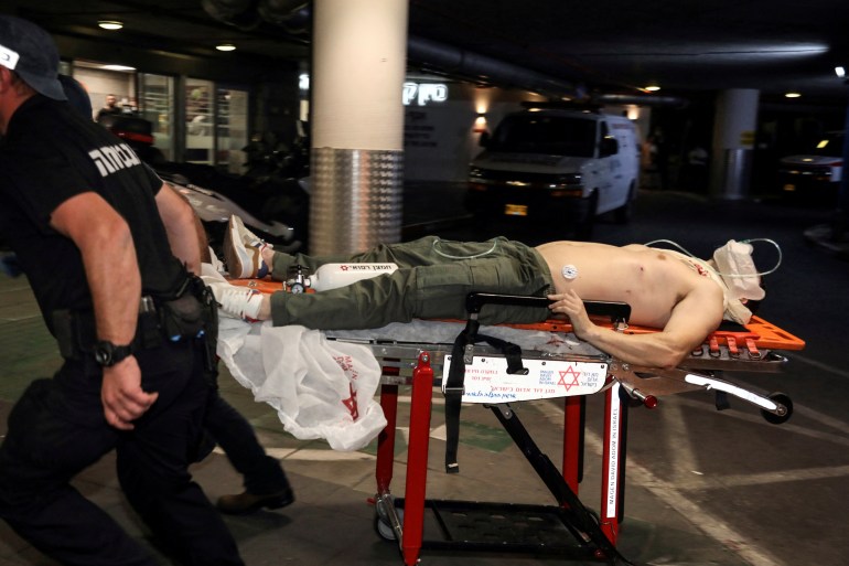 An injured man is rushed into hospital following an incident in Tel Aviv, Israel April 7, 2022. REUTERS/Gideon Markowicz ISRAEL OUT. NO COMMERCIAL OR EDITORIAL SALES IN ISRAEL