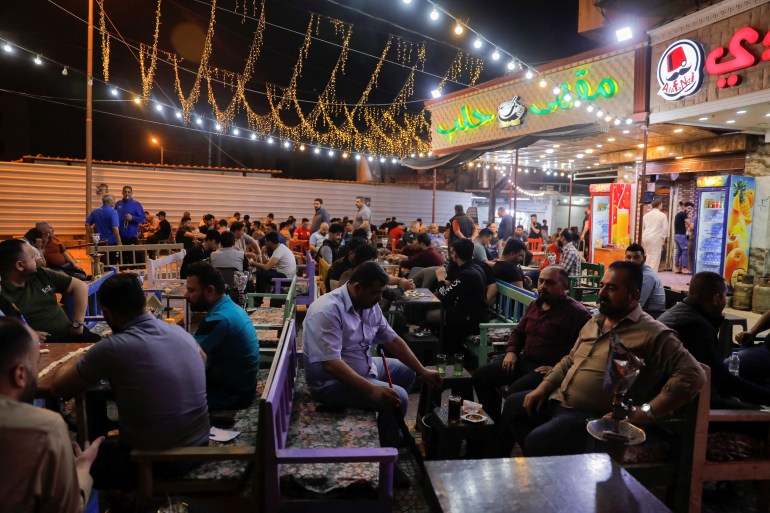 People sit in a popular cafe, during the holy month of Ramadan