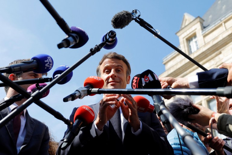 French President Emmanuel Macron, candidate for his re-election in the 2022 French presidential election, talks to journalists during a visit in Saint-Denis as he campaigns in Seine-Saint-Denis ahead of the second round of the presidential election, France, April 21, 2022. REUTERS/Gonzalo Fuentes