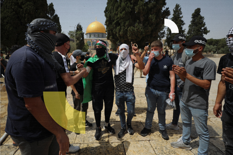 Palestinians stand together as the Dome of the Rock is seen in the background following clashes with Israeli police at the compound that houses al-Aqsa Mosque, known to Muslims as Noble Sanctuary and to Jews as Temple Mount, in Jerusalem's Old City May 10, 2021. REUTERS/Ammar Awad