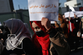An Afghan woman holds up a placard during a rally to protest against what the protesters say is Taliban restrictions on women, in Kabul, Afghanistan, December 28, 2021. REUTERS/Ali Khara