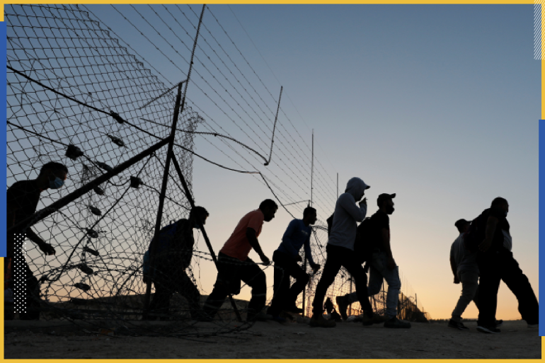 Palestinian laborers cross through an opening in a fence between the Israeli-occupied West Bank and Israel, as they head to work in Israel, near Hebron August 11, 2020. Picture taken August 11, 2020. REUTERS/Mussa Qawasma