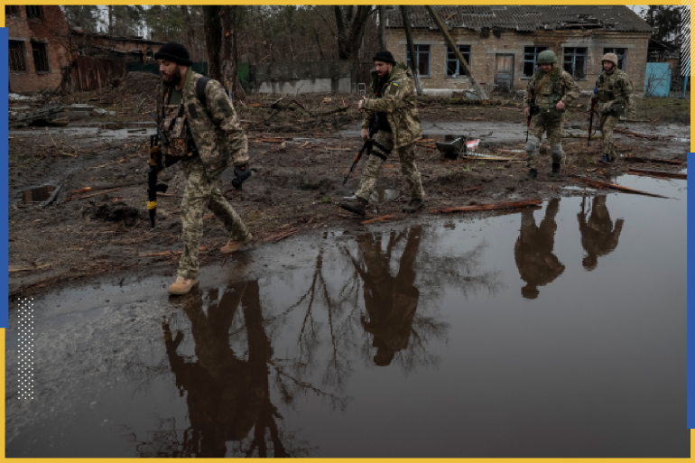Ukrainian service members walk on the street, amid Russia's invasion of Ukraine, near the village of Kozarovychi, in Kyiv region, Ukraine April 2, 2022. REUTERS/Gleb Garanich