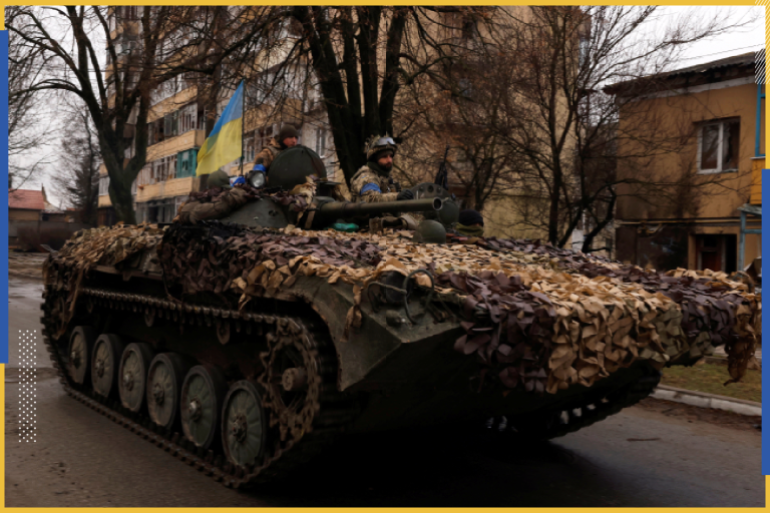 Ukrainian soldiers are pictured on their military vehicle, amid Russia's invasion on Ukraine in Bucha, in Kyiv region, Ukraine April 2, 2022. REUTERS/Zohra Bensemra
