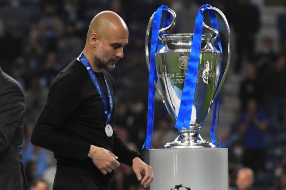 Champions League Final - Manchester City v Chelsea Soccer Football - Champions League Final - Manchester City v Chelsea - Estadio do Dragao, Porto, Portugal - May 29, 2021 Manchester City manager Pep Guardiola walks past the Champions League trophy after the match Pool via REUTERS/Pierre-Philippe Marcou TPX IMAGES OF THE DAY