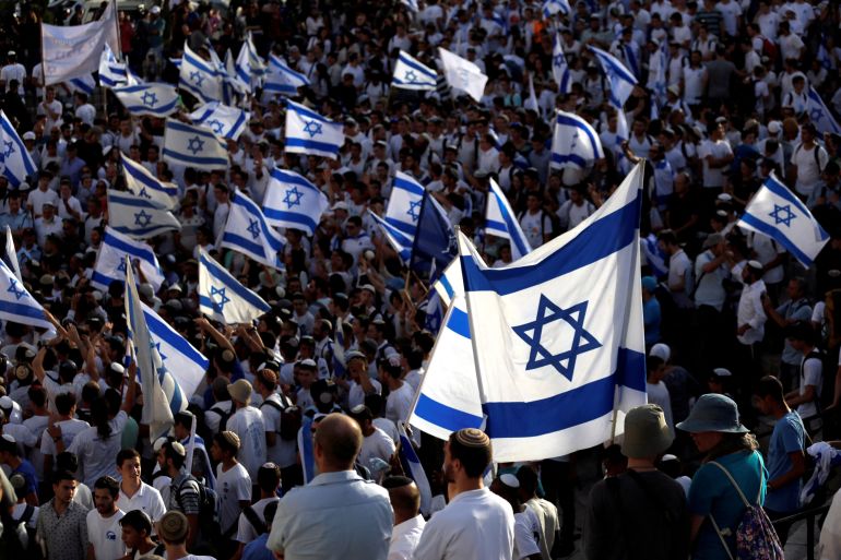FILE PHOTO: Israelis carry flags during a march marking Jerusalem Day, the anniversary of Israel's capture of East Jerusalem during the 1967 Middle East war, near Damascus Gate outside Jerusalem's Old City June 5, 2016. REUTERS/Amir Cohen/File Photo