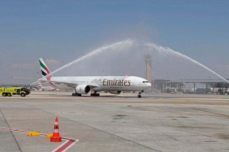 Emirates Boeing 777-300ER aircraft is given a welcoming water salute upon landing at Israel's Ben Gurion Airport in Lod on June 23, 2022, marking the airline's first passenger flight from the United Arab Emirates to Israel. (Photo by JACK GUEZ / AFP)
