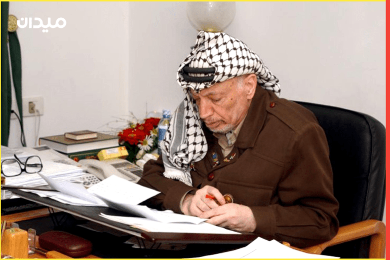 RAM01 - 20020225 - RAMALLAH, WEST BANK, - : Palestinian leader Yasser Arafat works at his desk in the West Bank town of Ramallah 25 February 2002. Israeli Prime Minister Ariel Sharon's government decided to allow Arafat to leave his compound in Ramallah, but not the city itself, where he has been cooped up since 03 December. EPA PHOTO PPO/HUSSEIN HUSSEIN/lg-ms