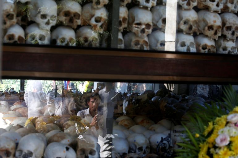 A man prays at the Choeung Ek memorial during the annual "Day of Anger" where people gathered to remember those who perished during the communist Khmer Rouge regime, outskirts of Phnom Penh