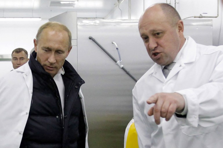 Businessman Yevgeny Prigozhin shows Russian Prime Minister Vladimir Putin his school lunch factory outside Saint Petersburg on September 20, 2010. Kremlin-linked businessman Yevgeny Prigozhin has filed a lawsuit in an EU court to remove him from the bloc's sanctions list, his company said on December 15, 2020. The European Union in October sanctioned Prigozhin -- nicknamed "Putin's chef" because his company Concord has catered for the Kremlin -- accusing him of undermining peace