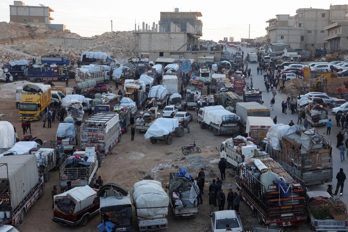 Hundreds of Syrian refugees have boarded a convoy of trucks in the Lebanese mountain town of Arsal to return to their war-torn country. [Mohamed Azakir/Reuters]