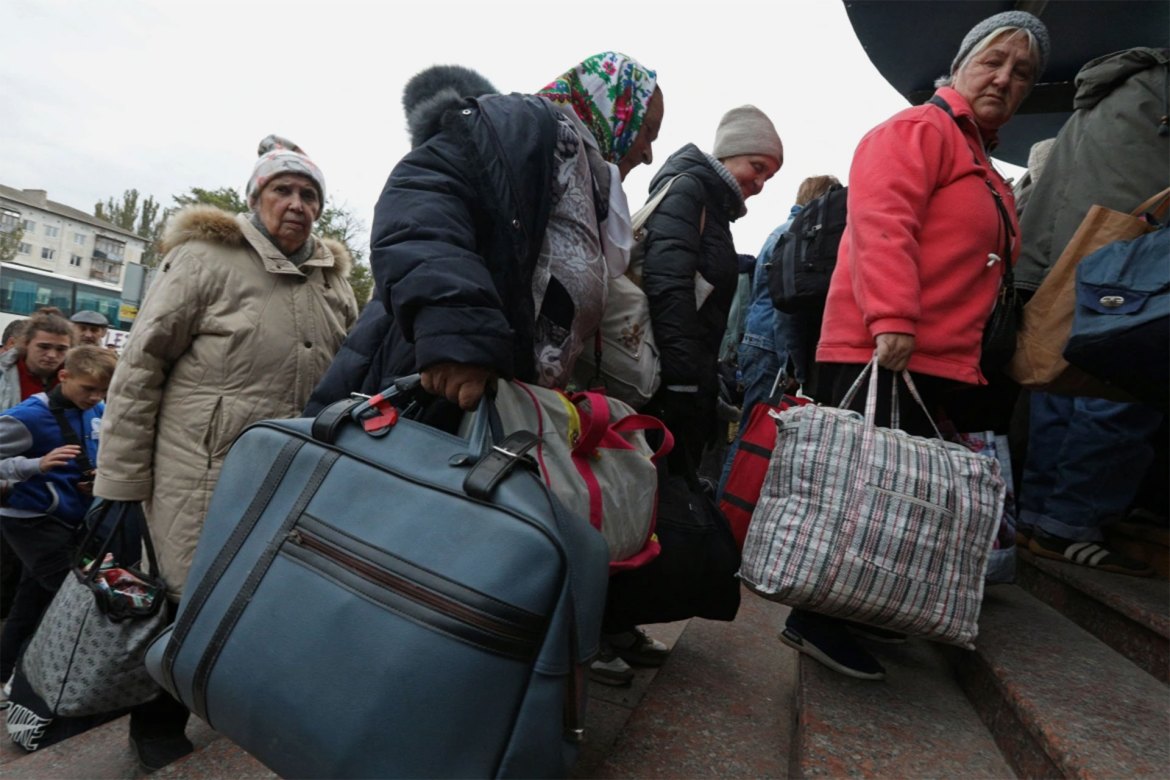 Civilians evacuated from Kherson arrive at a railway station in the town of Dzhankoi, Crimea. The battle for Kherson, which has been under Russian control for almost the whole of the eight-month invasion, appears to be reaching a critical juncture as advancing Ukrainian forces threaten to pin Russian troops along the Dnieper's west bank. [Alexey Pavlishak/Reuters]
