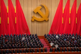 Delegates stand during the opening ceremony of the 20th National Congress of China's ruling Communist Party at the Great Hall of the People in Beijing. [Mark Schiefelbein/AP Photo]