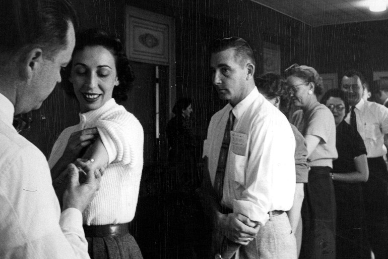 Denver Post Archives NOV 5 1957, NOV 6 1957 Denver Post Employees Get Flu Shots Dr. A.E. James gives an influenza vaccination to Helen Hertz of the general advertising department of The Denver Post as a line of other employees await their turn. James Mills, personnel director, said 400 employes will be vaccinated. Credit: Denver Post (Denver Post via Getty Images) GettyImages-836741138