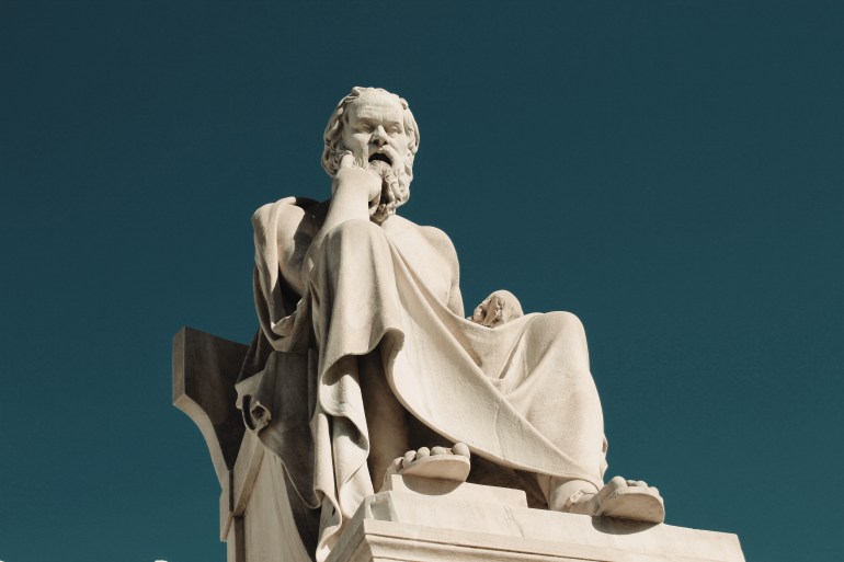 Statue of the ancient Greek philosopher Socrates in Athens, Greece. shutterstock_1716358459