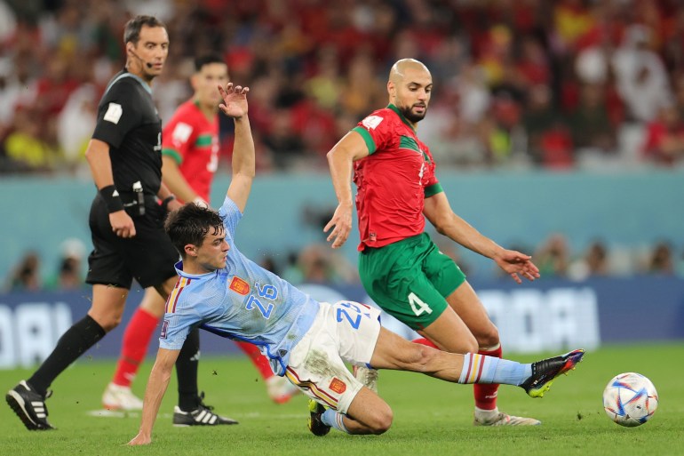 epa10352065 Sofyan Amrabat (R) of Morocco in action against Pedri of Spain during the FIFA World Cup 2022 round of 16 soccer match between Morocco and Spain at Education City Stadium in Doha, Qatar, 06 December 2022. EPA-EFE/Friedemann Vogel