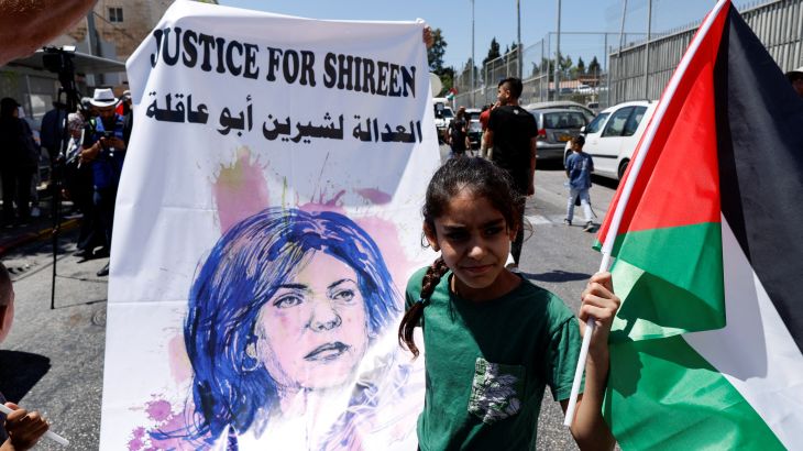 A Palestinian girl protests in support of slain Palestinian-American journalist Shireen Abu Akleh, as U.S. President Joe Biden visits Augusta Victoria Hospital, in Jerusalem
