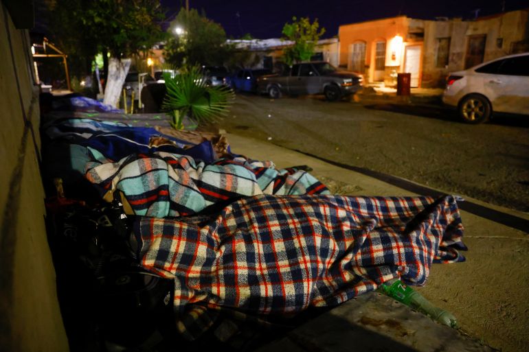 Venezuelan migrants sleep on the street after being evicted from a camp on the banks of the Rio Bravo river, in Ciudad Juarez