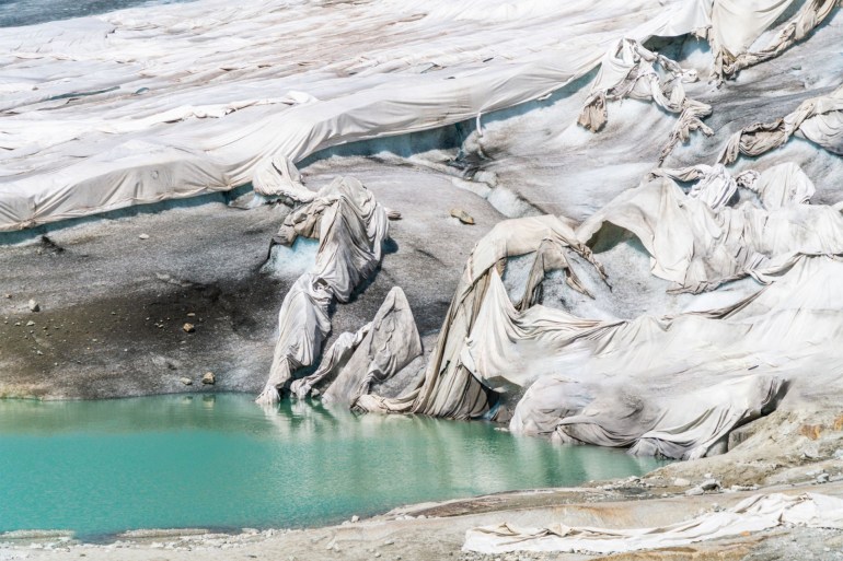 White blankets protecting Rhone Glacier from extreme melting due to global warming, Gletsch, canton of Valais, Switzerland gettyimages-1177102645
