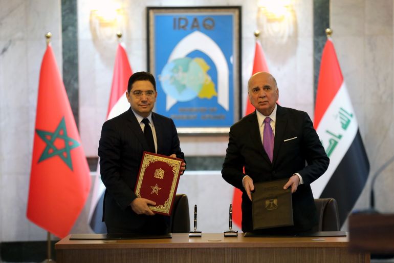 epa10436114 Foreign Minister of Iraq Fuad Hussein (R) and his Moroccan counterpart, Nasser Bourita (L) sign bilateral cooperation documents between the two countries at the Iraqi ministry of Foreign Affairs in Baghdad, Iraq, 28 January 2023. Bourita visits Iraq to hold talks with senior Iraqi officials and to reopen his country's embassy which was closed down 25 years ago. EPA-EFE/AHMED JALIL