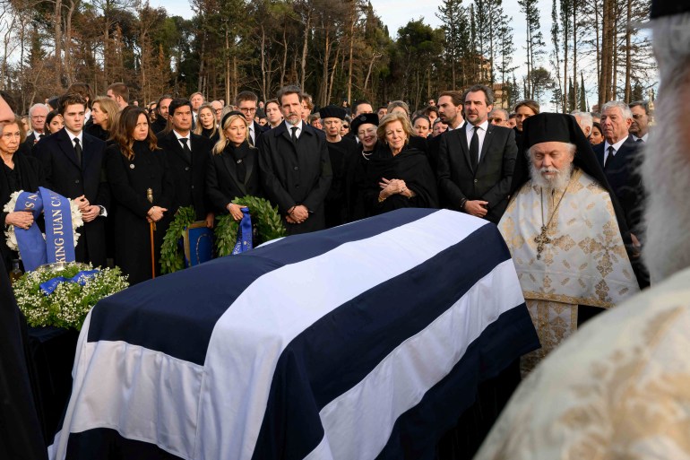 Members of the former Greek royal family stand next to the coffin of Greece's late former King Constantine II, during his funeral at the Tatoi estate, the summer palace of the former Greek royal family, in Athens, Greece, January 16, 2023. Nikolas Kominis/Studio Kominis/Handout via REUTERS NO RESALES.NO ARCHIVES.