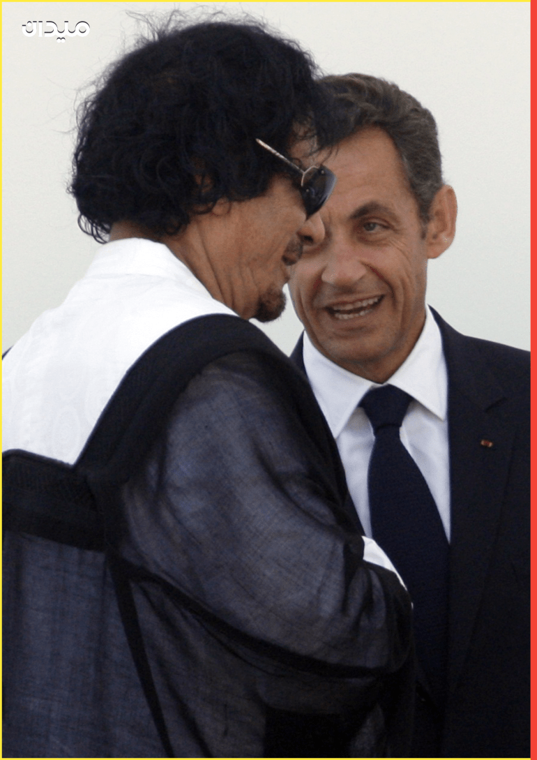 Libya's leader Gaddafi speaks with France's President Sarkozy as he leaves the final meeting at the G8 summit in L'Aquila