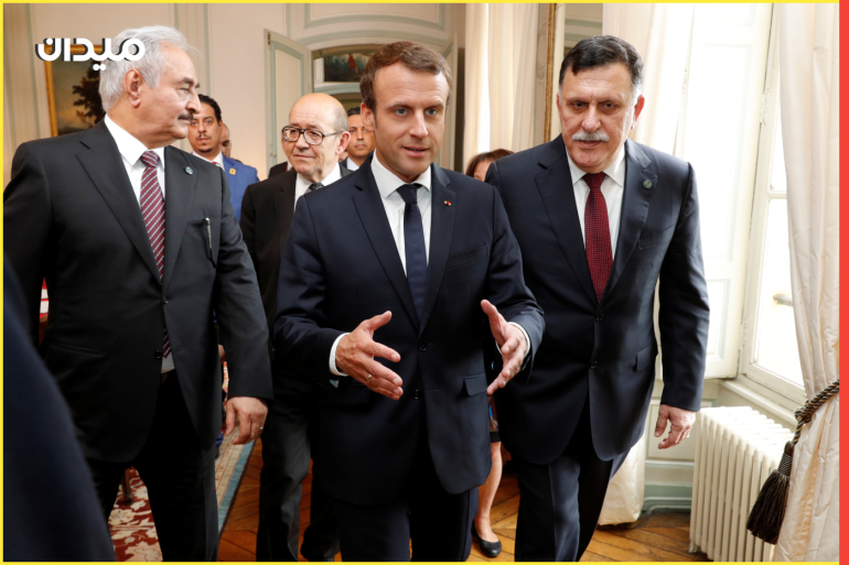 French President Emmanuel Macron walks with Libyan Prime Minister Fayez al-Sarraj (R), General Khalifa Haftar (L), commander in the Libyan National Army (LNA), and French Europe and Foreign Minister Jean-Yves Le Drian (2ndL) before a meeting for talks over a political deal to help end Libya’s crisis in La Celle-Saint-Cloud near Paris, France, July 25, 2017. REUTERS/Philippe Wojazer/POOL