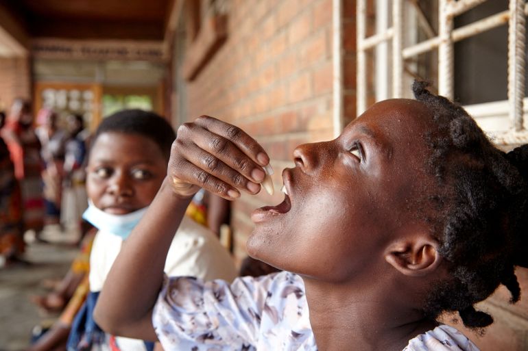 FILE PHOTO: Eliza Tangwe, 18, takes a dose of oral cholera vaccine at a health centre in response to the latest cholera outbreak in Blantyre, Malawi, November 16, 2022. REUTERS/Eldson Chagara/File Photo