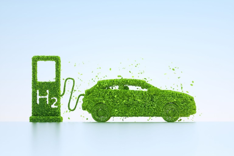 Digital generated image of car plugged into H2 hydrogen charging station made out of leaves on light blue background.
