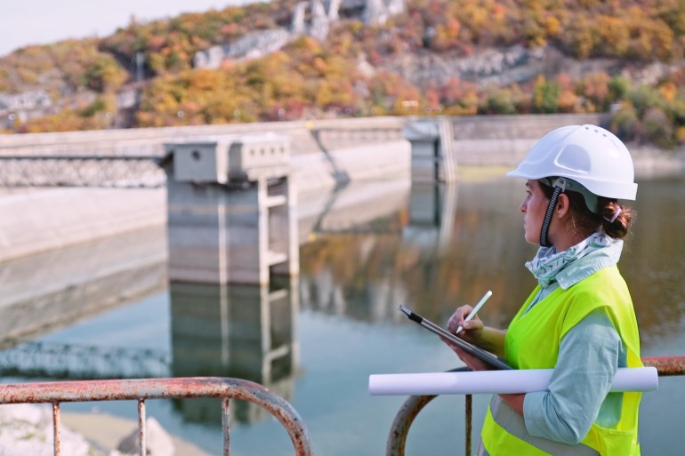 Working day on a hydroelectric power plant. Checking the condition of the power equipment, and analysing the data and the results of measurements with a mobile app.