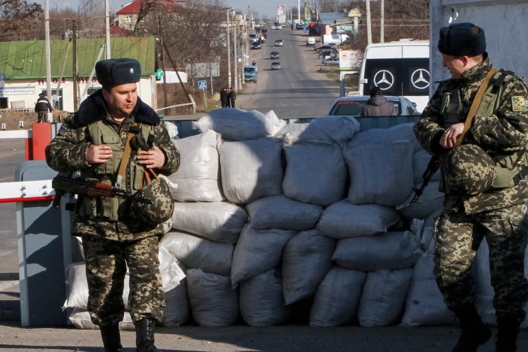 Ukrainian border guards stand at a checkpoint at the border with Moldova breakaway Transnistria region, near Odessa