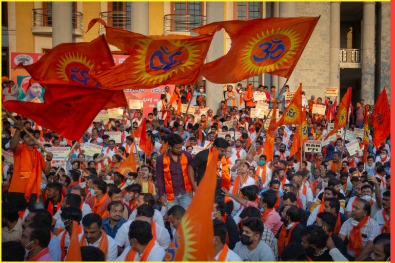BENGALURU, INDIA - FEBRUARY 23: Protestors affiliated with various Hindu organizations wave flags and placards during a demonstration against the killing of Harsha, a member of a Hindu group, on February 23, 2022 in Bengaluru, India. The murder of Harsha, 28, a member of the right-wing organization Bajrang Dal, in Shivamogga (Shimoga) in Karnataka, has created deep fissures in the state already reeling under instances of communal disharmony, with the latest flare up occurring when several colleges in the state barred Muslim students from attending classes while wearing the hijab. (Photo by Abhishek Chinnappa/Getty Images)