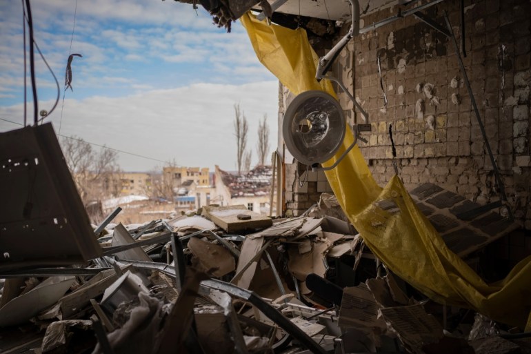 An operating light hangs from the ceiling of the destroyed surgery section of the hospital in Izyum. [Vadim Ghirda/AP Photo]