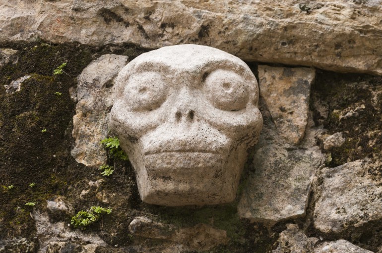 Mexico, Yucatan, Quintana Roo, Coba Mayan site, Grupo Coba, skull motif relief carving
