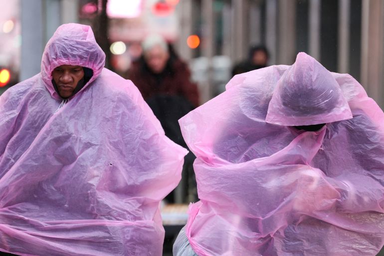 People make their way through snow during a winter storm in New York