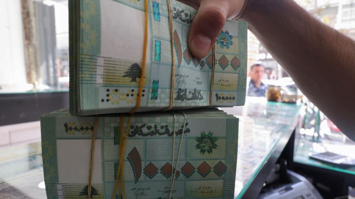 A money exchange vendor displays Lebanese pound banknotes at a shop in Beirut