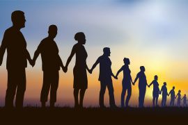 shutterstock_1752529031 Concept of the human chain and solidarity with a group of aligned people who join hands to show that unity is strength.